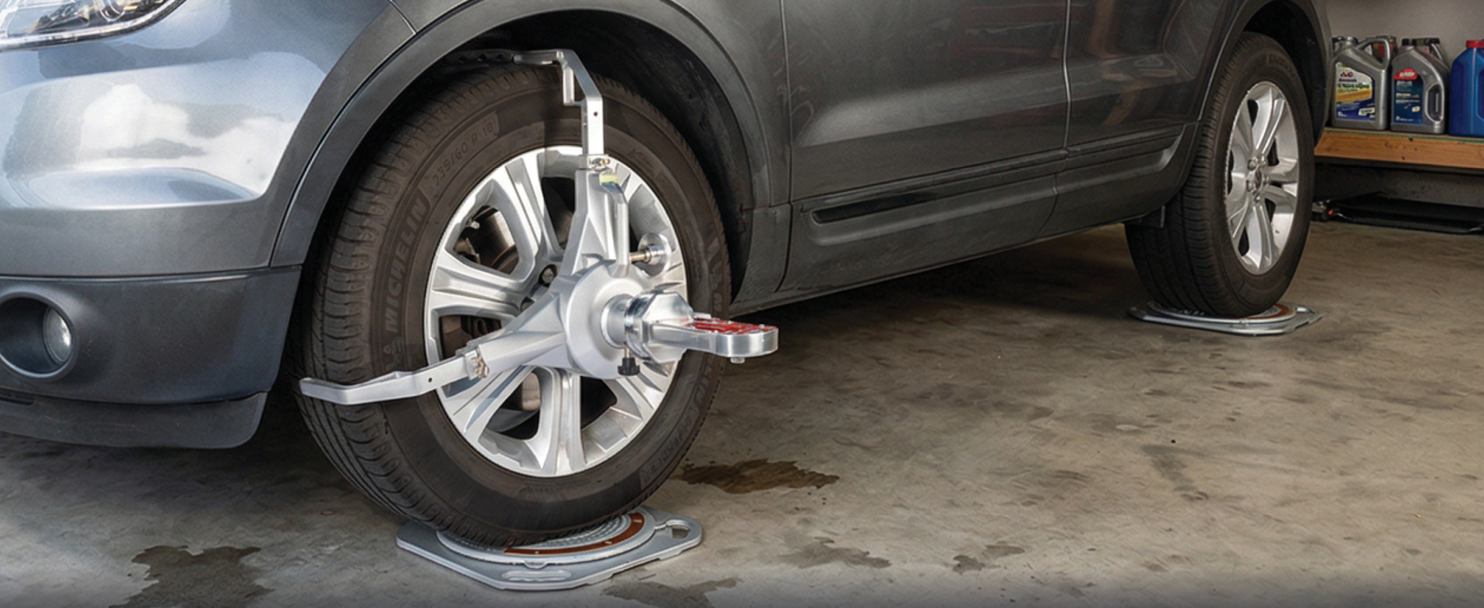 AutoSolo ASCCKG camber, caster, and KPI gauge mounted on a wheel during home garage alignment