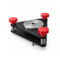 AutoSolo Runout Compensation Adapter, angled view with two matte black steel plates, three red knobs, the steel center disc and the chrome plug