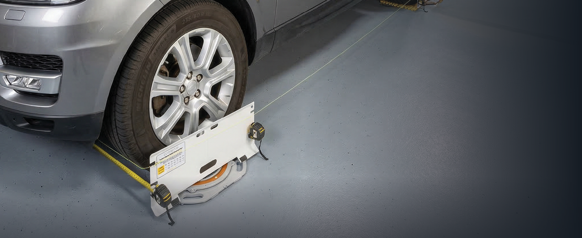 AutoSolo ASTPSETX toe plates installed for alignment measurement on a vehicle