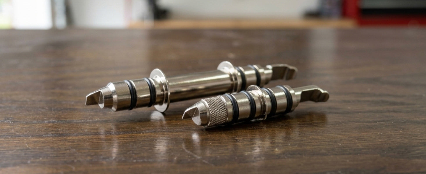 An 88 mm and a 137 mm locator pin side by side on a workbench