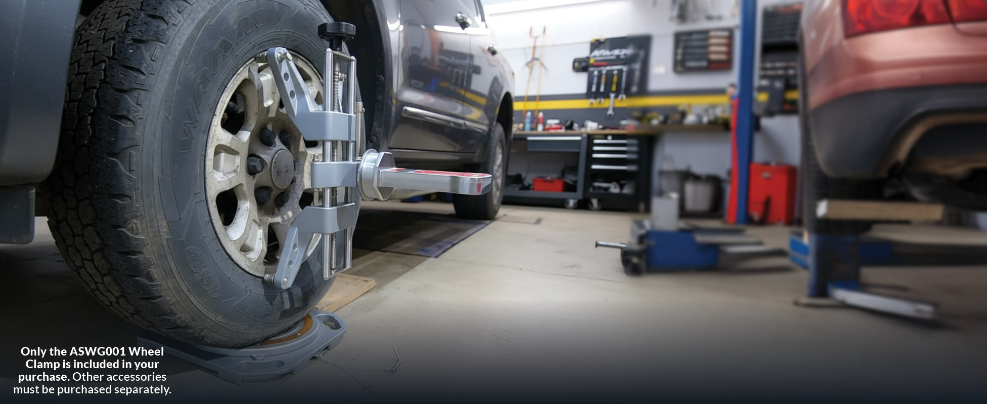 AutoSolo ASWG001 wheel clamp mounted on a truck wheel inside a workshop