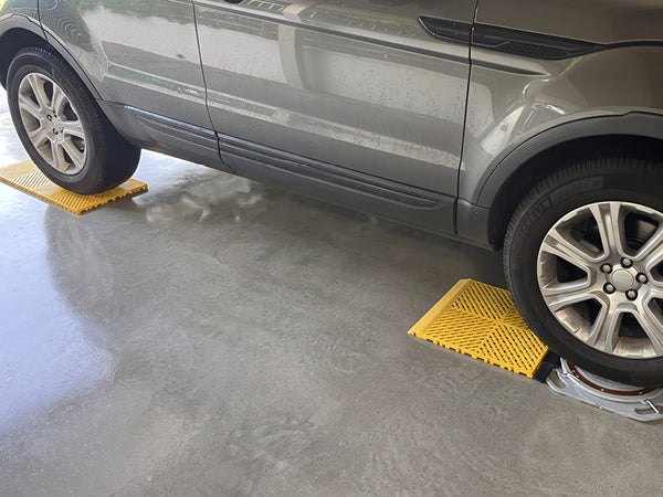 Car sitting on AutoSolo ramps and level platforms with turn plates under the front wheels