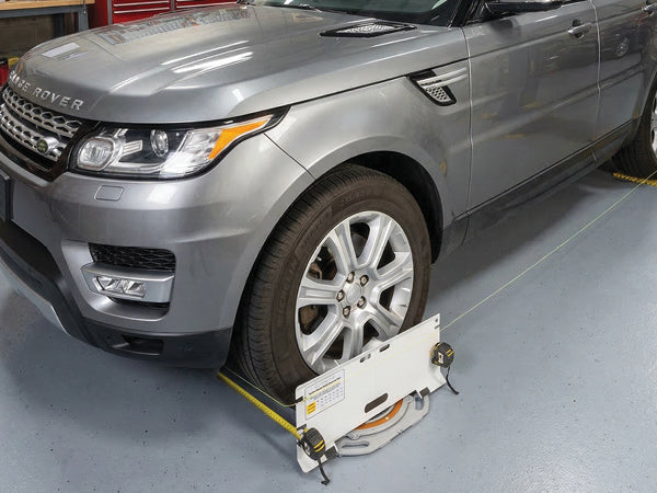 AutoSolo ASTPSETX toe plate against a front tire sidewall with tape measures and string under tension