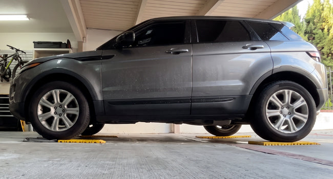 Car sitting level on AutoSolo ramps and level platforms, all four corners at one height